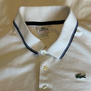 Lacoste white polo with black and blue accent on collar and sleeves